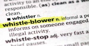 Whistleblower defined on a piece of paper.
