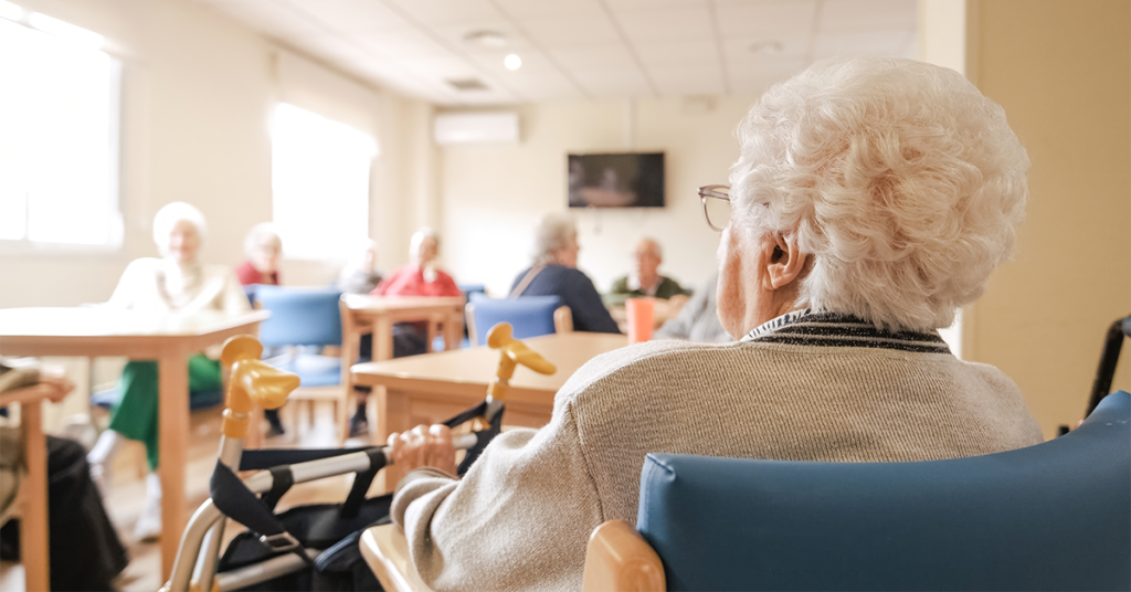 Elderly woman with foldable walker in nursing home