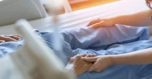 holding hospice patients hand